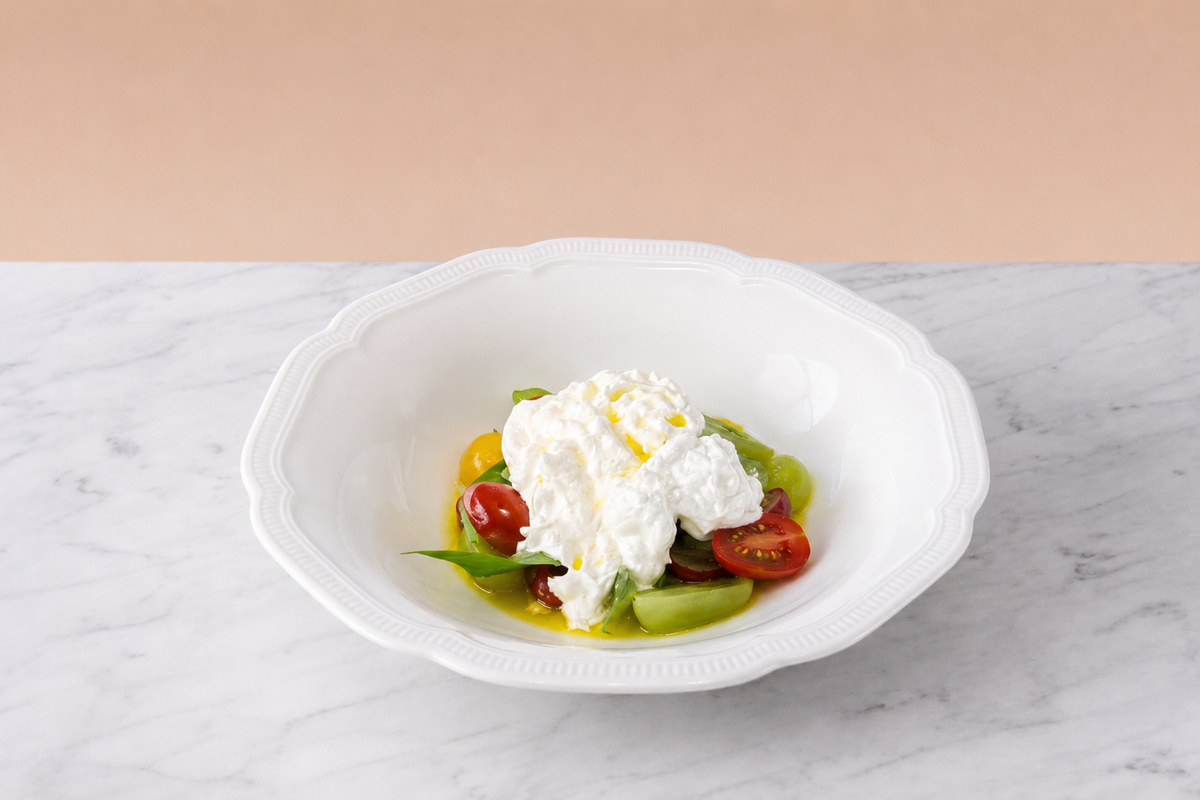 Burrata with tomatoes , grapes and citrus dressing